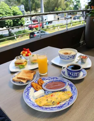 a table topped with plates of breakfast foods and drinks at Terra Bella Hotel Boutique in San Salvador
