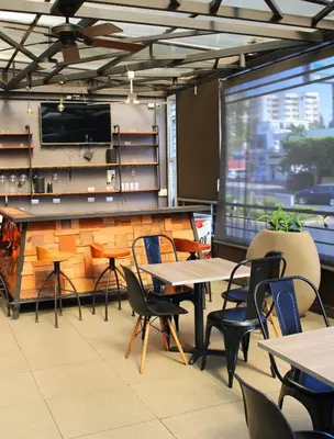a restaurant with tables and chairs and a counter at Terra Bella Hotel Boutique in San Salvador
