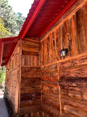 a wall of a wooden building with a light on it at Villa Verde in Perquín