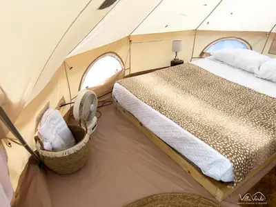 a bedroom with a bed in a tent at Villa Verde in Perquín