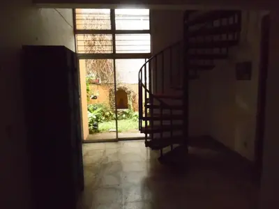 an empty hallway with a large window and a staircase at Hostal Cumbres de El Salvador in San Salvador