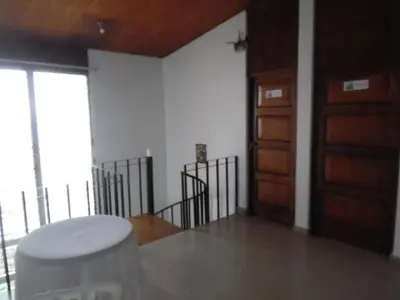 a room with a door and a stool in a room at Hostal Cumbres de El Salvador in San Salvador