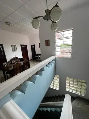 a staircase in a room with a dining room at Hostal Cumbres del Volcan Flor Blanca in San Salvador