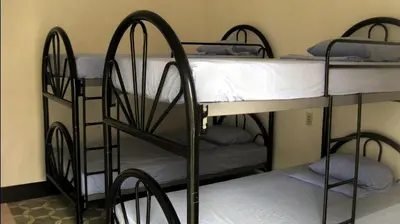 two sets of bunk beds in a room at Hostal Cumbres del Volcan Flor Blanca in San Salvador