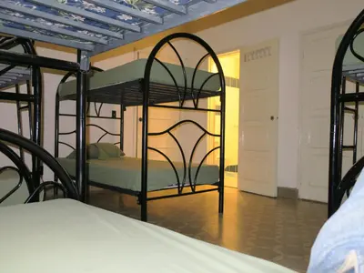 a bedroom with two bunk beds in a room at Hostal Cumbres del Volcan Flor Blanca in San Salvador