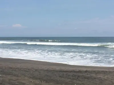 a sandy beach with waves in the ocean at Coco Blue a New Beach Resort in La Libertad