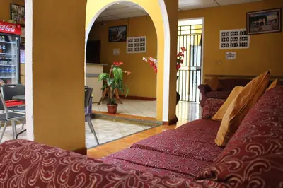 a view of a living room with a couch in a room at Hotel Pasadena II in San Salvador