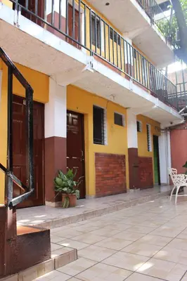 an empty courtyard of a building with a balcony at Hotel Pasadena II in San Salvador