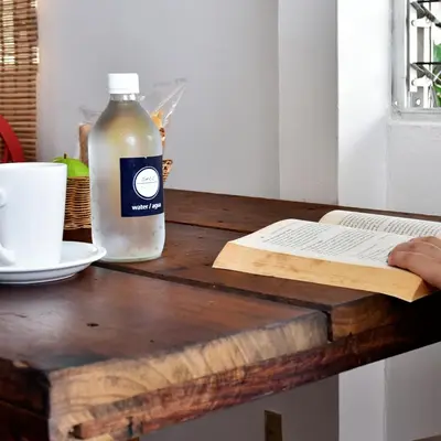 a bottle of milk sitting on top of a wooden table at Cinco Hotel B&B in San Salvador