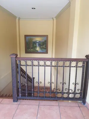 a stairwell with a railing and a painting on the wall at Hotel Florencia in San Miguel