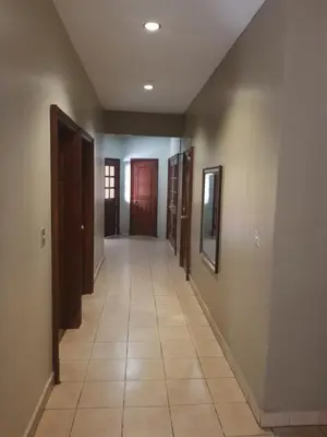 a hallway of a house with doors and a tile floor at Hotel Florencia in San Miguel
