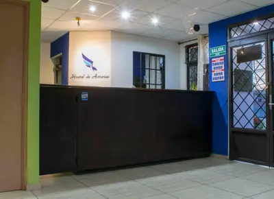 a entrance to a hospital with a gate and a door at Hostal de Asturias in San Salvador