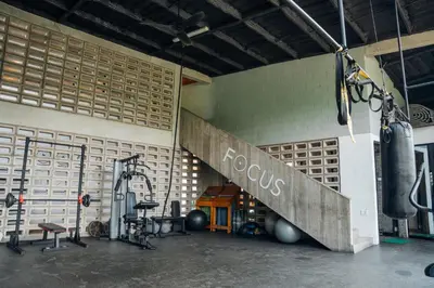 a gym with a punching bag and weights at Puro Surf Hotel & Performance Academy in El Zonte