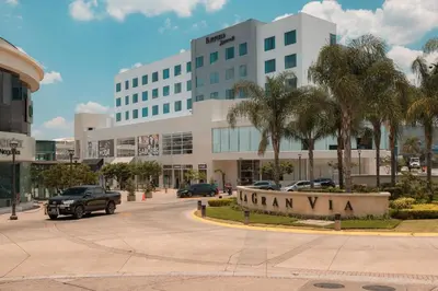 a parking lot in front of a large building at Fairfield by Marriott San Salvador in San Salvador