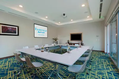 a conference room with a large white table and chairs at Fairfield by Marriott San Salvador in San Salvador