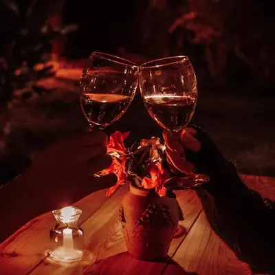 two people holding up wine glasses on a table at Hotel Juayua in Juayúa