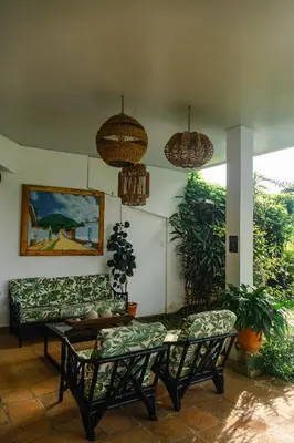 a living room with couches and a table at Hotel Juayua in Juayúa