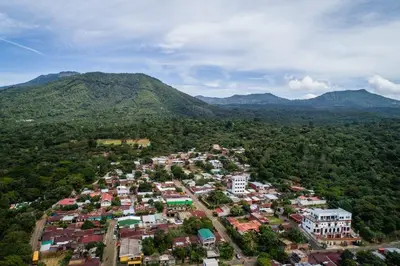 an aerial view of a city with mountains in the background at Vista Los Volcanes Hotel y Restaurante in Juayúa