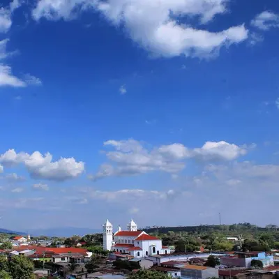 a view of a city with a blue sky at Vista Los Volcanes Hotel y Restaurante in Juayúa