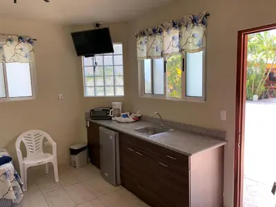 a kitchen with a sink and a counter at Hotel y Restaurante Rincón Familiar in La Libertad