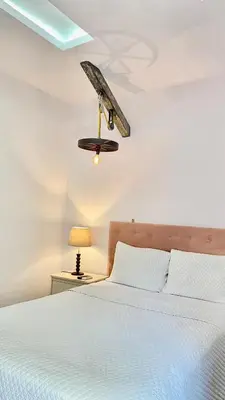 a bedroom with a bed and a ceiling fan at Velvet hotel centro histórico in Santa Ana