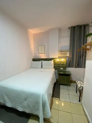 a bedroom with a large white bed in a room at Velvet hotel centro histórico in Santa Ana