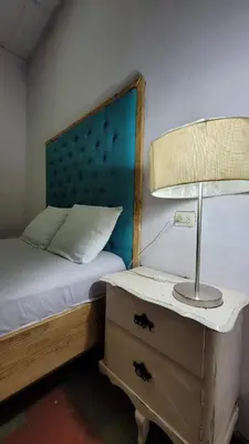 a bedroom with a bed and a lamp on a dresser at Velvet hotel centro histórico in Santa Ana