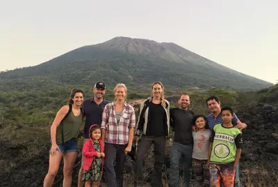 a family poses in front of a mountain at Hotel Europa in San Miguel