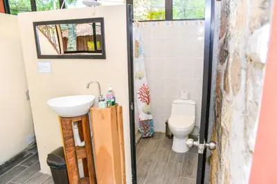 a bathroom with a sink and a toilet at Hotel y Restaurante Las Margaritas in Perquín