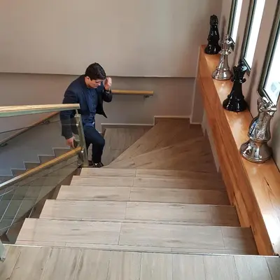 a man climbing the stairs in a building at Remfort Hotel in Santa Ana