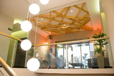 a lobby with several lights hanging from a ceiling at Remfort Hotel in Santa Ana