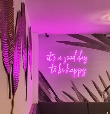 a neon sign that says its a good day to be happy at Remfort Hotel in Santa Ana