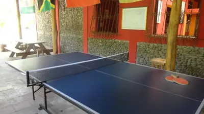 a ping pong table in a ping pong room at Hotel & Bar La Guitarra in El Sunzal
