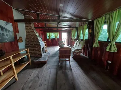 a living room with wooden floors and a brick fireplace at Alla Arriba in Las Cruces