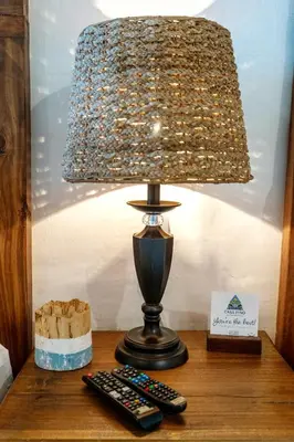 a lamp sitting on a table with two remote controls at Hotel Casa Pino, Tu Casa en Ataco in Concepción de Ataco