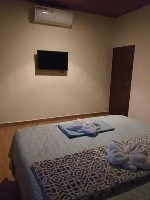 a bedroom with a bed with towels on it at Hostal DEYLUWIN in Juayúa
