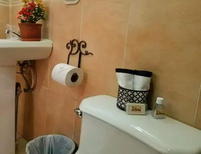 a small bathroom with a toilet and a sink at Hostal Las Puertas in Santa Ana