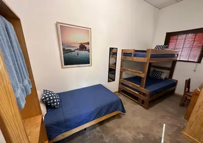 a bedroom with a bunk bed and a ladder at Hotel Michanti in El Zonte