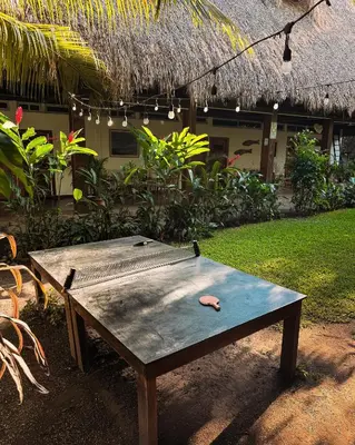 a wooden table sitting in front of a house at Hotel Michanti in El Zonte