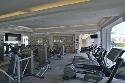a gym with treadmills and elliptical machines at Real Intercontinental San Salvador by IHG in San Salvador