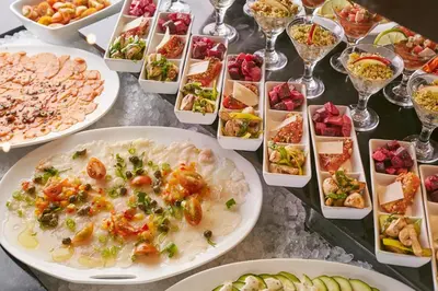 a table filled with plates of food and glasses of wine at Real Intercontinental San Salvador by IHG in San Salvador