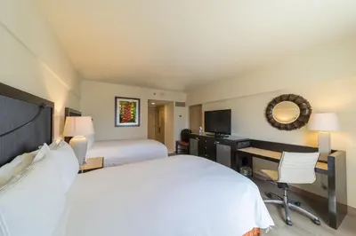 a hotel room with a bed and a desk with a computer at Real Intercontinental San Salvador by IHG in San Salvador