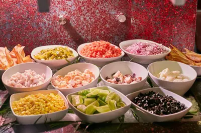a group of bowls filled with different types of food at Real Intercontinental San Salvador by IHG in San Salvador