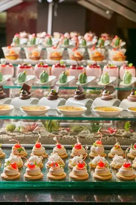 a bunch of cakes and pastries on a display at Real Intercontinental San Salvador by IHG in San Salvador