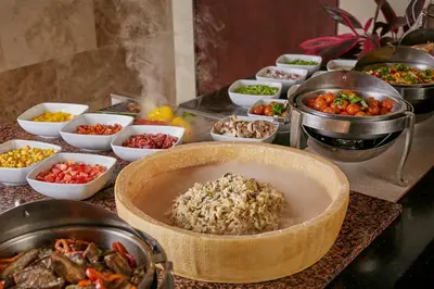a buffet of food with rice and other foods at Real Intercontinental San Salvador by IHG in San Salvador