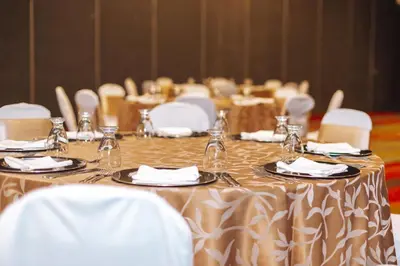 a set of tables with plates and glasses on them at Holiday Inn San Salvador by IHG in San Salvador