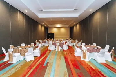 a banquet hall with tables and chairs and a stage at Holiday Inn San Salvador by IHG in San Salvador