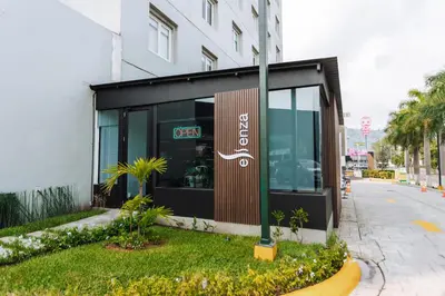 a restaurant with a sign on the side of a building at Holiday Inn San Salvador by IHG in San Salvador
