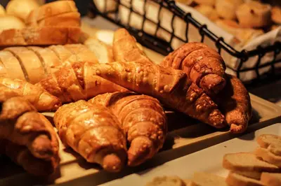 a bunch of different types of bread and pastries at Holiday Inn San Salvador by IHG in San Salvador