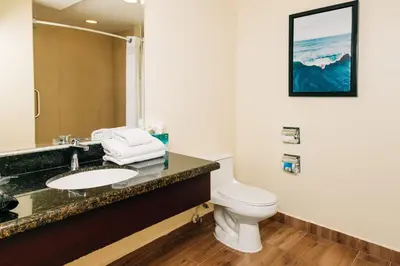 a bathroom with a sink and a toilet at Holiday Inn San Salvador by IHG in San Salvador
